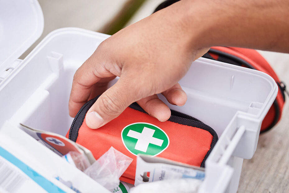 a STCW medical care provider reaches into a first aid kit to provide care to an injured team member